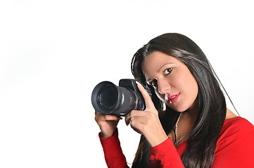 Image showing Young woman holding camera in hand taking picture isolated