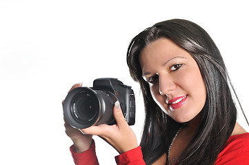 Image showing Young woman holding camera in hand taking picture isolated