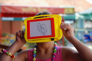 Image showing Cute litlle girl drawing