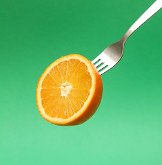 Image showing orange on fork