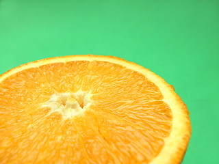 Image showing sliced orange macro on green background