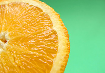 Image showing sliced orange macro on green background