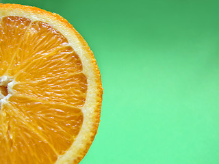 Image showing sliced orange macro on green background