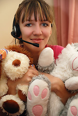Image showing Cute young woman huging toys