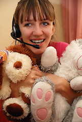 Image showing Cute young woman huging toys