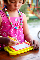 Image showing Cute litlle girl drawing