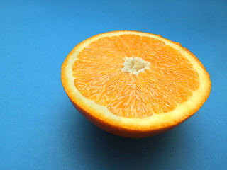 Image showing sliced orange macro with blue background