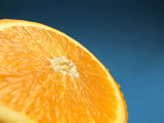 Image showing sliced orange macro with blue background