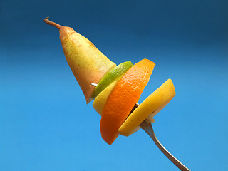 Image showing sliced fruits on fork