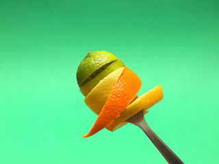 Image showing orange and lemon slices on fork