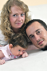 Image showing indoor portrait with happy young family and  cute little babby 