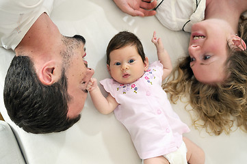 Image showing indoor portrait with happy young family and  cute little babby 