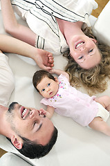 Image showing indoor portrait with happy young family and  cute little babby 