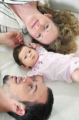 Image showing indoor portrait with happy young family and  cute little babby 