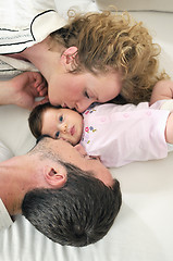 Image showing indoor portrait with happy young family and  cute little babby 