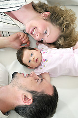 Image showing indoor portrait with happy young family and  cute little babbybe