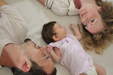 Image showing young family playing with cute little baby