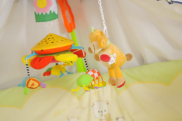 Image showing baby bed with colorful toys indoor