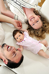 Image showing indoor portrait with happy young family and  cute little babby 