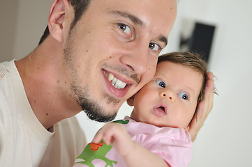 Image showing indoor portrait with happy young famil and  cute little babby 