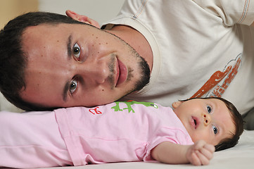 Image showing indoor portrait with happy young famil and  cute little babby 