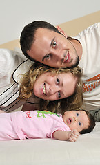 Image showing indoor portrait with happy young famil and  cute little babby 