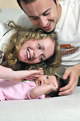 Image showing indoor portrait with happy young famil and  cute little babby 