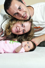 Image showing indoor portrait with happy young famil and  cute little babby 