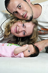 Image showing indoor portrait with happy young famil and  cute little babby 