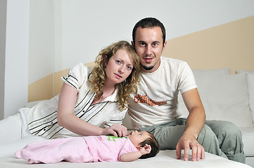 Image showing indoor portrait with happy young famil and  cute little babby 