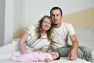 Image showing indoor portrait with happy young famil and  cute little babby 