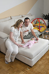 Image showing indoor portrait with happy young famil and  cute little babby 