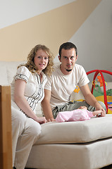 Image showing indoor portrait with happy young famil and  cute little babby 