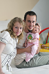 Image showing indoor portrait with happy young family and  cute little babby 