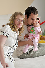 Image showing indoor portrait with happy young famil and  cute little babby 