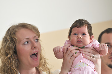 Image showing indoor portrait with happy young family and  cute little babby 