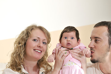 Image showing indoor portrait with happy young family and  cute little babby 