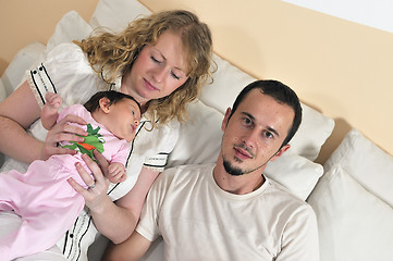 Image showing indoor portrait with happy young family and  cute little babby 