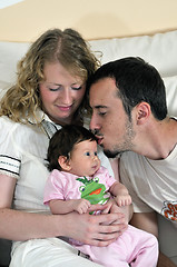 Image showing indoor portrait with happy young family and  cute little babby 