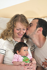 Image showing indoor portrait with happy young family and  cute little babby 