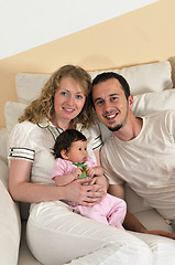 Image showing indoor portrait with happy young family and  cute little babby 