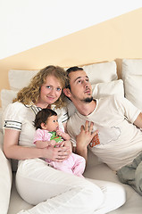 Image showing indoor portrait with happy young family and  cute little babby 