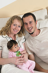 Image showing indoor portrait with happy young family and  cute little babby 