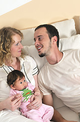 Image showing indoor portrait with happy young family and  cute little babby 