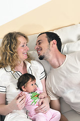 Image showing indoor portrait with happy young family and  cute little babby 