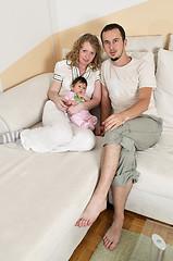 Image showing indoor portrait with happy young family and  cute little babby 