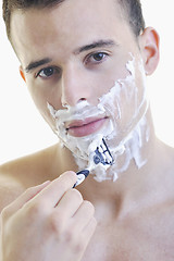 Image showing young man shaving