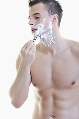 Image showing young man shaving