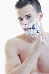 Image showing young man shaving