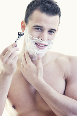 Image showing young man shaving